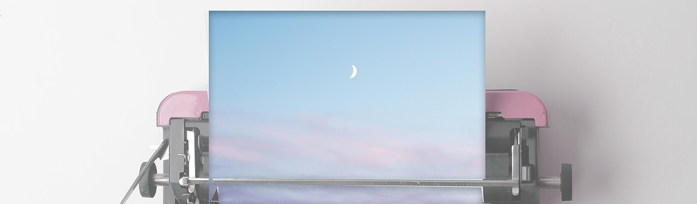 Typewriter set with blank page of dusky skies and crescent moon.